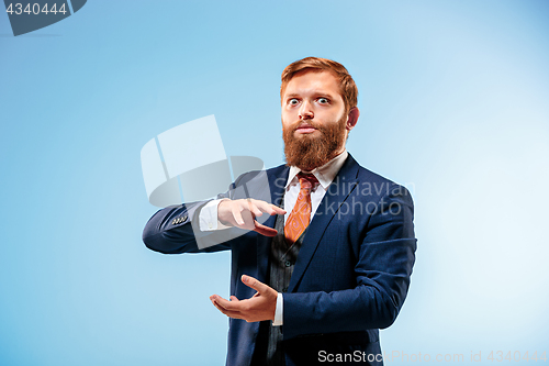 Image of Portrait of a business man isolated on blue background.