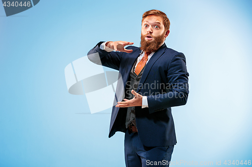 Image of Portrait of a business man isolated on blue background.