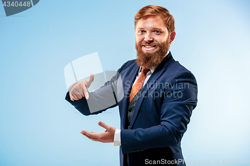 Image of Portrait of a business man isolated on blue background.