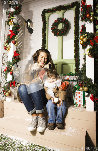 Image of happy smiling family on Christmas at house with gifts, young mot