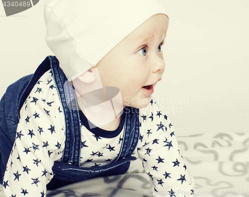Image of little cute baby toddler on carpet isolated close up smiling ado