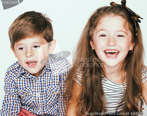 Image of little cute boy and girl hugging playing on white background, ha