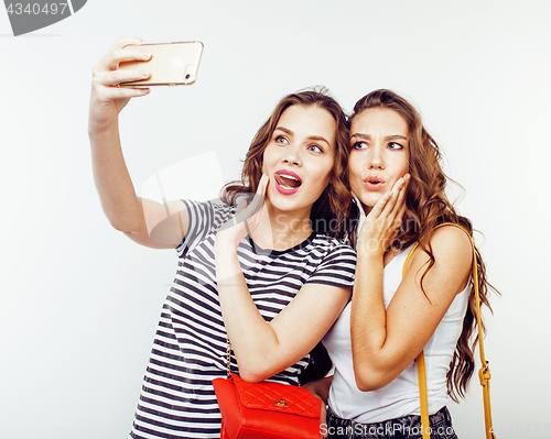 Image of best friends teenage girls together having fun, posing emotional on white background, besties happy smiling, lifestyle people concept close up. making selfie