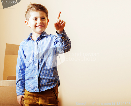 Image of little cute boy in empty room, remoove to new house. home alone,