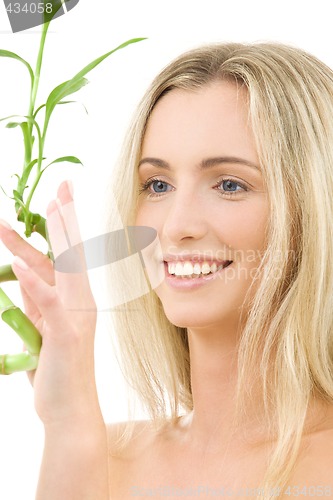 Image of happy blonde with bamboo