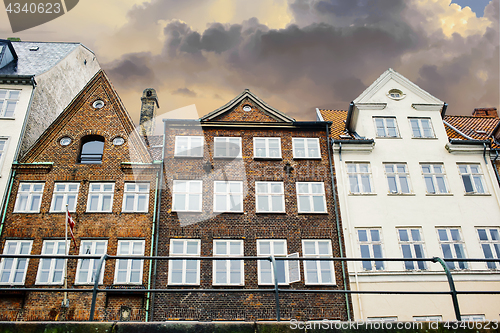 Image of Dramatically sunset clouds above the buildings