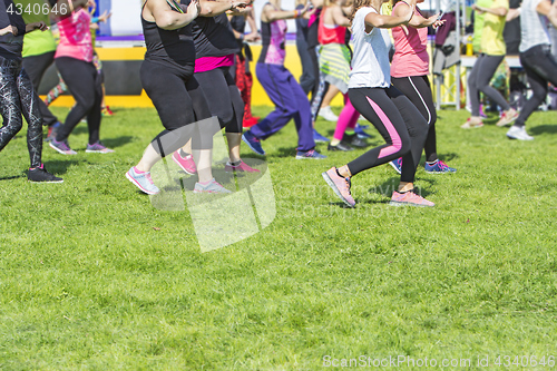 Image of Group of young girls exercising fitness with dancing in the city