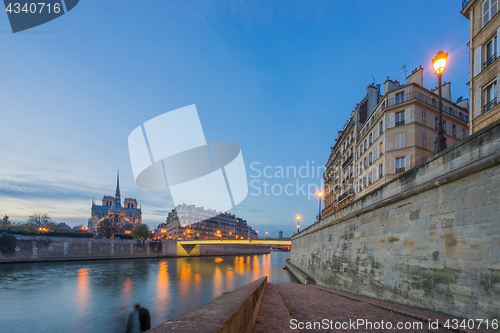 Image of Notre Dame Cathedral with Paris cityscape at dus