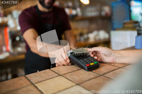 Image of hands with payment terminal and credit card