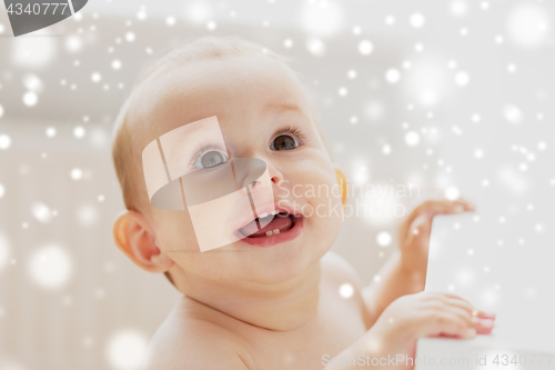 Image of face of happy little baby boy or girl looking up