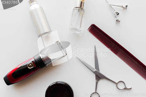 Image of styling hair spray, trimmer and scissors