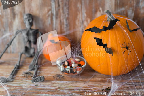 Image of halloween pumpkins, skeleton and candies