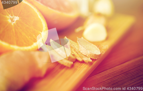 Image of ginger, garlic and orange on wooden board