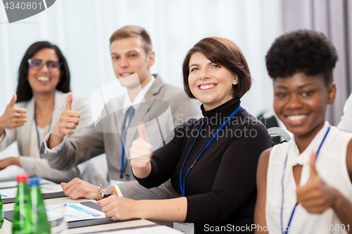 Image of people at business conference showing thumbs up