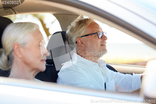 Image of happy senior couple driving in car