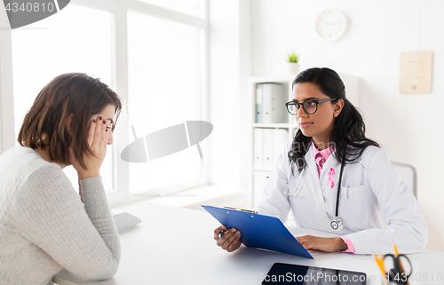 Image of doctor with pink awareness ribbon and sad patient