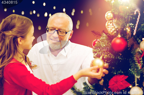 Image of happy family decorating christmas tree