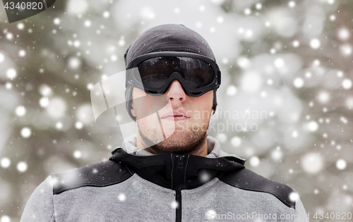 Image of sports man with ski goggles in winter outdoors