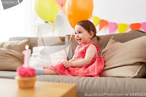 Image of happy baby girl on birthday party at home