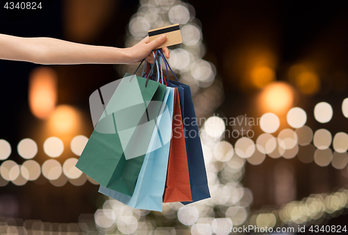 Image of shopping bags and credit card in hand at christmas