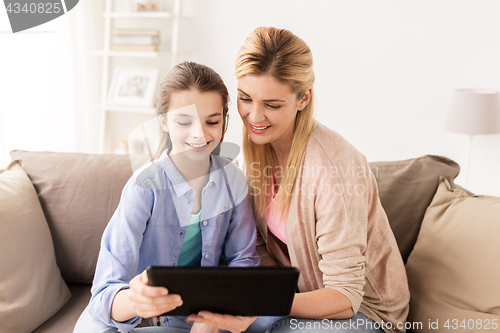 Image of happy family with tablet pc at home