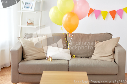 Image of sofa at home room decorated for birthday party