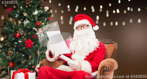 Image of man in costume of santa claus with letter