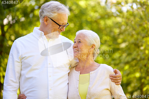 Image of happy senior couple hugging at summer park