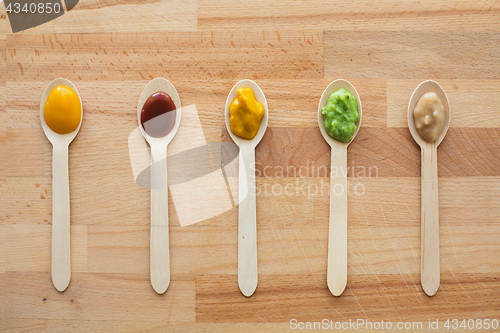 Image of vegetable or fruit puree or baby food in spoons