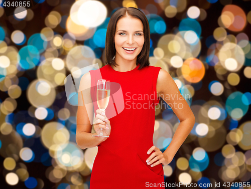 Image of smiling woman holding glass of sparkling wine