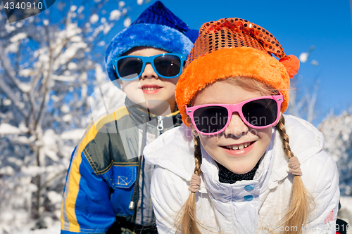 Image of Happy little children playing  in winter snow day.