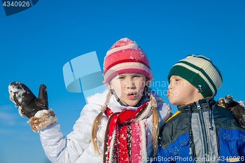 Image of Happy little children playing  in winter snow day.