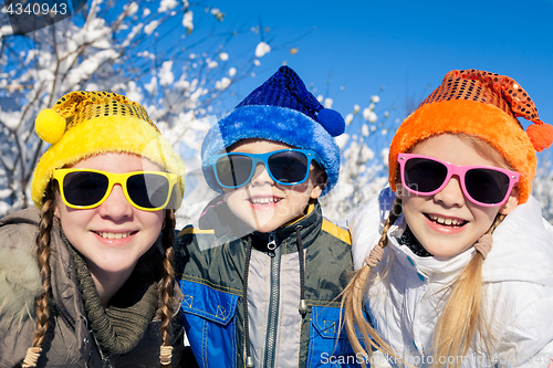 Image of Happy little children playing  in winter snow day.