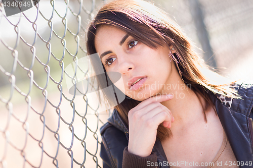 Image of Beautiful Meloncholy Mixed Race Young Woman Portrait Outside.