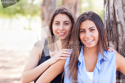 Image of Two Beautiful Ethnic Twin Sisters Portrait Outdoors.