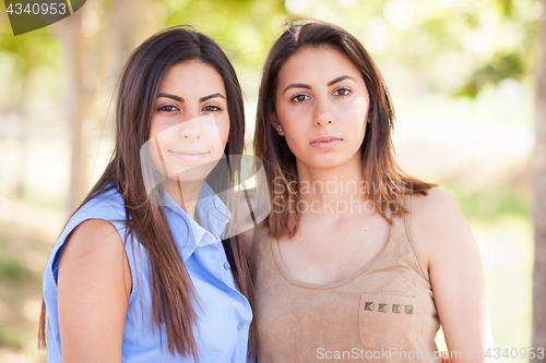 Image of Two Beautiful Ethnic Twin Sisters Portrait Outdoors.