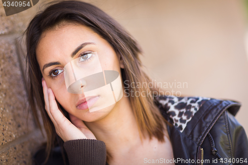 Image of Beautiful Meloncholy Mixed Race Young Woman Portrait Outside.