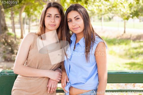 Image of Two Beautiful Ethnic Twin Sisters Portrait Outdoors.