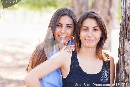 Image of Two Beautiful Ethnic Twin Sisters Portrait Outdoors.