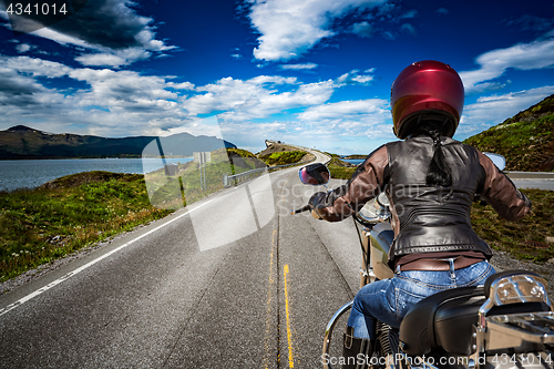 Image of Biker girl rides a mountain road in Norway Atlantic Ocean Road. 