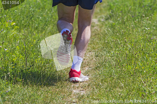 Image of Young athlete running marathon outdoors