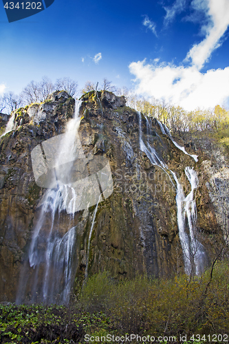 Image of Plitvice Lakes with a big waterfall under the blue sky National 