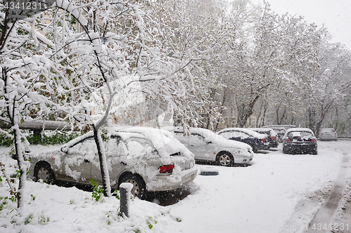 Image of snow covered cars at winter parking