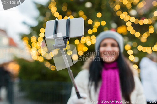 Image of woman taking selfie with smartphone at christmas 