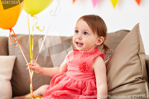 Image of happy baby girl on birthday party at home