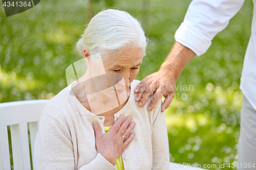 Image of senior woman feeling sick at summer park