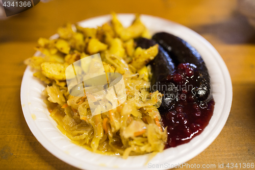 Image of braised cabbage and sausages with sauce on plate