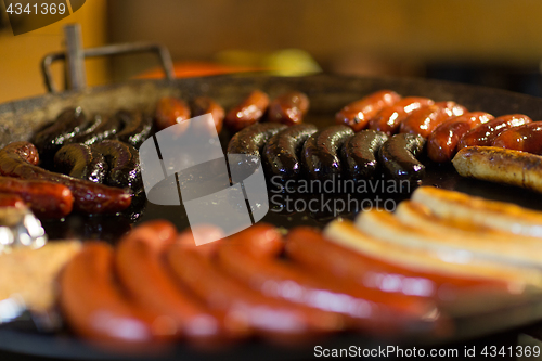 Image of sausages and salmon frying in stir fry pan