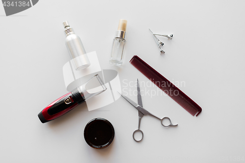 Image of styling hair spray, trimmer and scissors