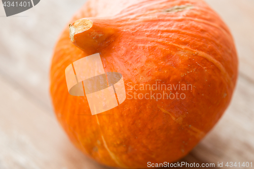 Image of close up of pumpkin on wooden table